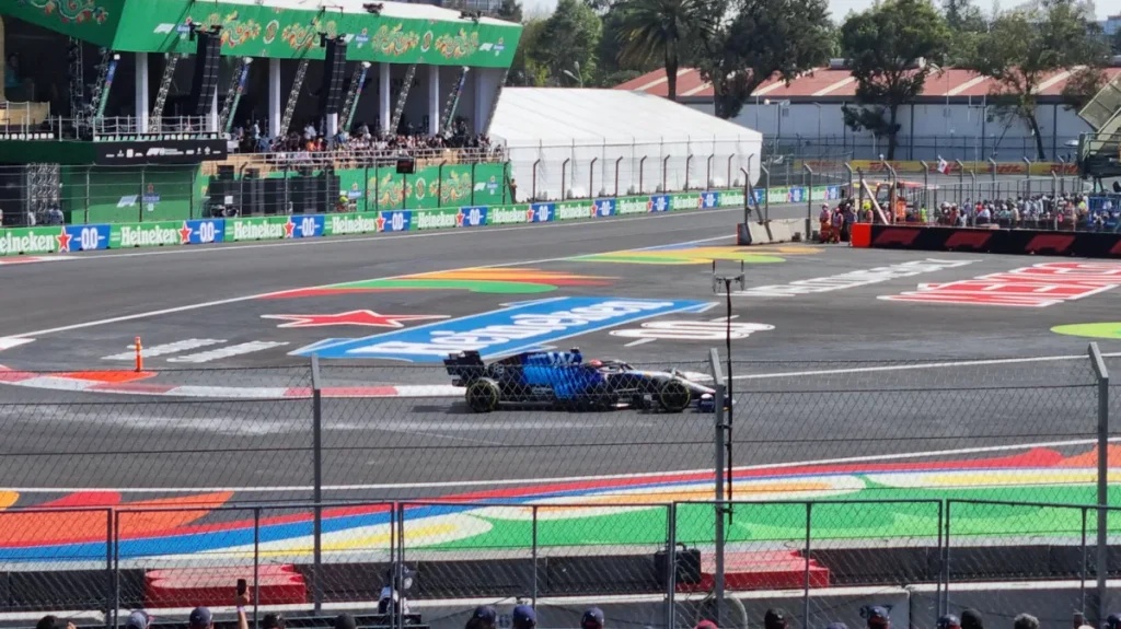 Formula 1 cars racing at f1 mexico city high altitude down the main straight