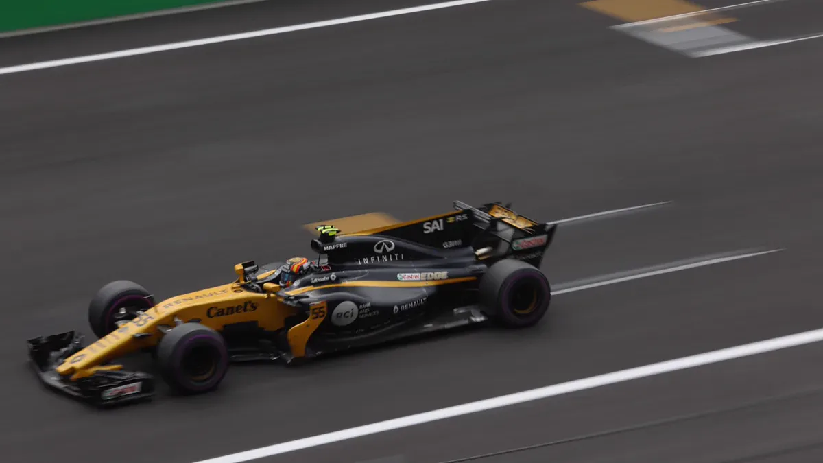 Formula 1 car carrying Monaco-spec high downforce wings through Mexico stadium complex
