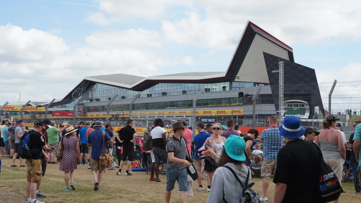 Modern paddock hospitality lounge building requiring smart casual race weekend paddock outfits